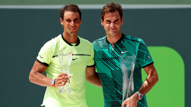 Rafael Nadal of Spain (L) and Roger Federer of Switzerland (R) hold the finalist and Butch Buchholz trophy, respectively, after their match in the men’s singles championship of the 2017 Miami Open at Crandon Park Tennis Center.